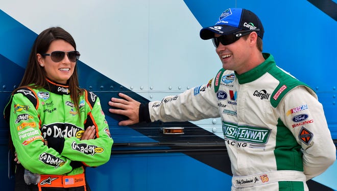Danica Patrick, left,  and Ricky Stenhouse Jr. share a laugh before practice for the NASCAR Nationwide Series race at Indianapolis Motor Speedway on July 26, 2012.