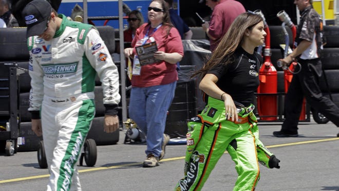 Danica Patrick runs past Ricky Stenhouse Jr. before practice for Saturday's History 300 Nationwide Series race in Concord, N.C., May 24, 2012.