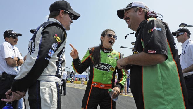 Danica Patrick jokes with Tony Eury Jr. (right) and Ricky Stenhouse Jr. during qualifying for the Nationwide Series race in Concord, N.C., May 26, 2012.
