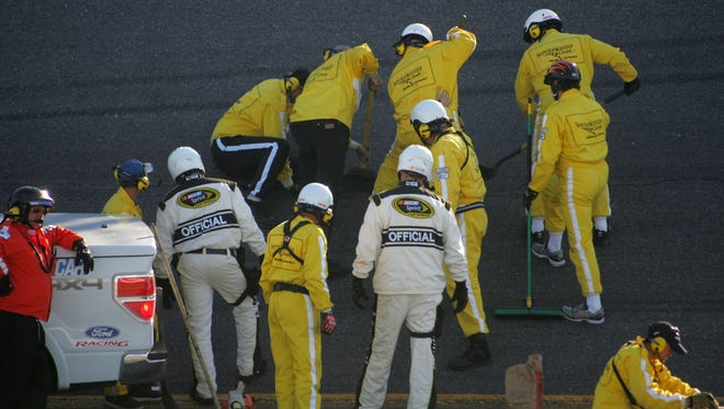 Workers repair damage to the track as a result of a pothole in Turn 2 on lap 122 during the 2010 Daytona 500. The race was red-flagged for almost two hours before Jamie McMurray eventually won.