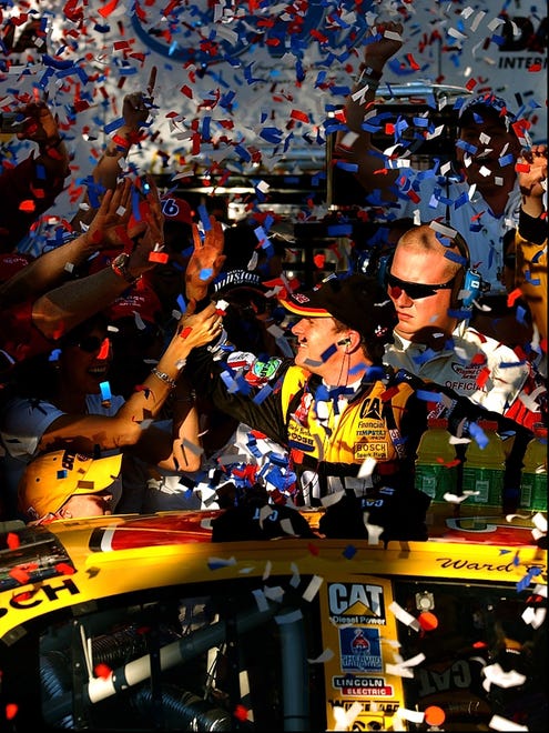 Ward Burton, center, is showered with confetti in victory lane after winning the 2002 Daytona 500 after Sterling Marlin's penalty.