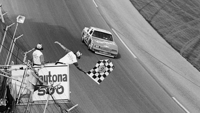 Cale Yarborough takes the checkered flag at the Daytona 500 for the final time in 1984. Yarborough also won in 1983, '77, and '68.