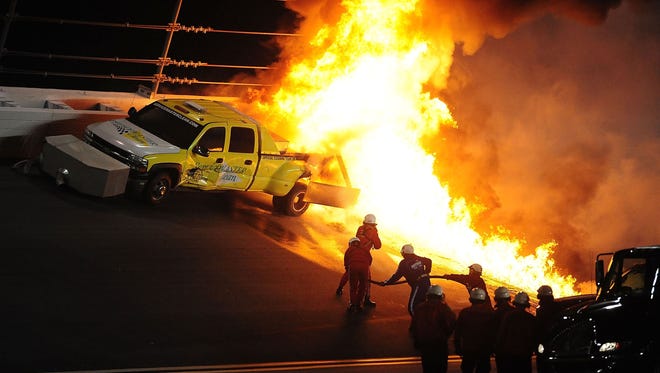 Safety crews work to put out a fire from a jet-fueled track dryer that was hit by Juan Pablo Montoya's car (not pictured) under caution during the 2012 Daytona 500.