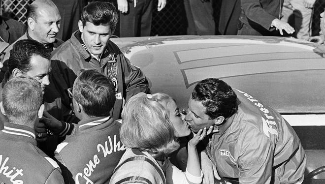 Former Miss USA Diana Batts, of Washington, D.C., gives a big kiss to Mario Andretti after he won the 1967 Daytona 500. Andretti remains the only driver ever to win the Indianapolis 500 (1969), Daytona 500 (1967) and the Formula One World Championship (1978).