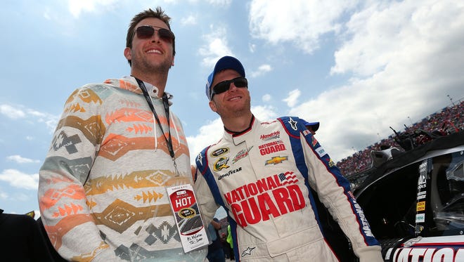 Dale Earnhardt Jr., right, poses with University of Alabama quarterback AJ McCarron on the grid at Talladega Superspeedway prior to the start of the 2013 Aaron's 499.