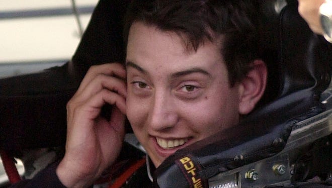 NASCAR Busch Series driver Kyle Busch smiles as he prepares to exit his car following a qualification run of 189.847 mph that earned him the pole position for the O'Reilly 300 race, Thursday April 1, 2004.