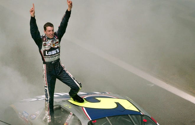 Kyle Busch (5) stands on his car on the frontstretch celebrating his win in the NASCAR Busch Series Carquest Auto Parts 300 at the Lowe's Motor Speedway in Concord, N.C., Saturday, May 29, 2004. (AP Photo/Rusty Burroughs) ORG XMIT: CHL202