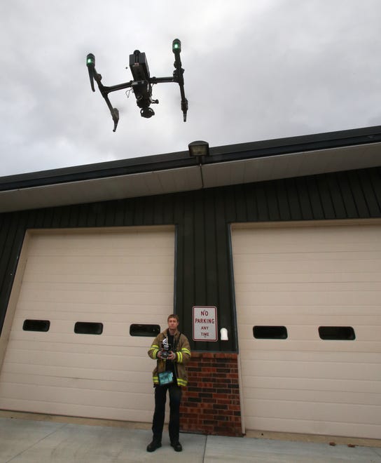 Merton Firefighter Josh Paral demonstrates the department's new drone with high-definition color and infrared video cameras that can be flown up to 400 feet.