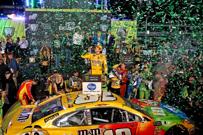 Kyle Busch celebrates in victory lane with his No. 18 Joe Gibbs Racing team after winning the 2019 NASCAR Cup Series championship at Homestead-Miami Speedway.