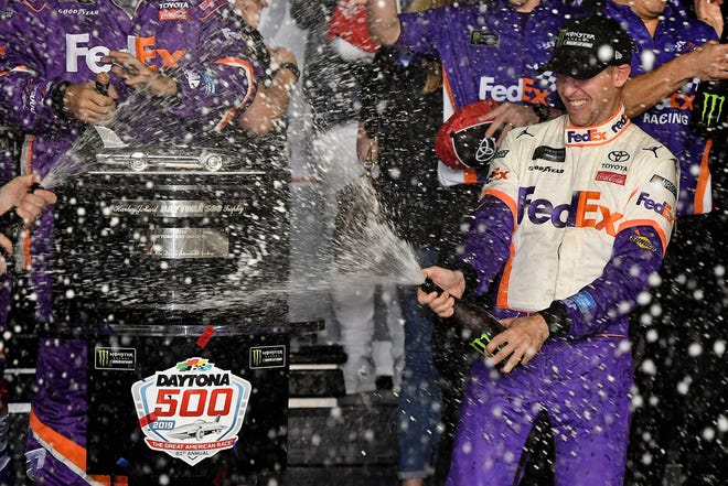 Denny Hamlin sprays champagne in victory lane after winning his second career Daytona 500 in 2019.