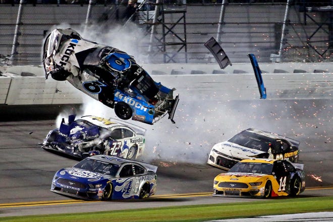 Ryan Newman (6) goes airborne after crashing into the wall and getting hit by Corey LaJoie (32) on the final lap of the 2020 Daytona 500, won by Denny Hamlin (not pictured) in a photo finish.