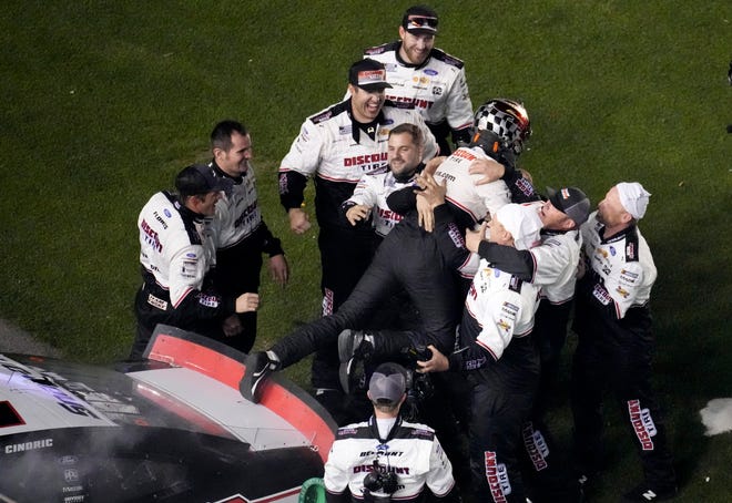 Austin Cindric jumps from the hood of his No. 2 Ford into the arms of his Team Penske crew after winning the 2022 Daytona 500 on Feb 20. Cindric making just his eighth NASCAR Cup Series start became the second youngest winner in Daytona 500 history at age 23.