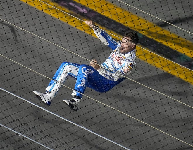 Ricky Stenhouse Jr. climbs the fence at Daytona International Speedway after winning the 2023 Daytona 500 to snap a 199-race winless drought.