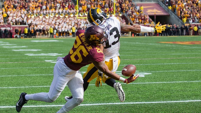 Oct 8, 2016; Minneapolis, MN, USA; Minnesota Golden Gophers wide receiver Brian Smith (26) attempts to make a catch behind Iowa Hawkeyes defensive back Greg Mabin (13) in the second half at TCF Bank Stadium. The Hawkeyes won 14-7. Mandatory Credit: Jesse Johnson-USA TODAY Sports