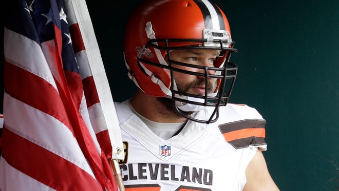 Cleveland Browns' Joe Thomas waits with an American flag to run onto the field before the game against the Philadelphia Eagles, Sunday on Sept. 11, 2016, in Philadelphia.