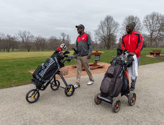 Anthony Ross Jr. and his father, Anthony Ross Sr., of Menomonee Falls head out for an afternoon of golfing at Wanaki Golf Course in Menomonee Falls on Friday, April 24, 2020. Courses across the state were allowed to open at 8 a.m. in accordance with Gov. Tony Evers' revised safer-at-home order.
